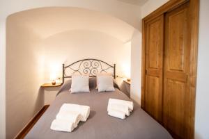 a bedroom with a bed with two towels on it at Casetta di Butia, Appartamento Iris in Lucca