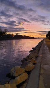 a kite flying over a body of water at sunset at Studio 237 Port Camargue, Piscine, Climatisation, 2 personnes in Le Grau-du-Roi