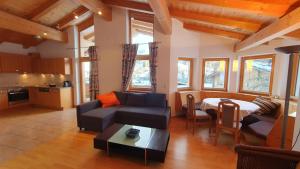 a living room with a couch and a table at Haus Carina in Kirchberg in Tirol