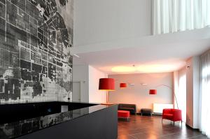 a living room with a black and white wall at BB Hotels Aparthotel Arcimboldi in Milan