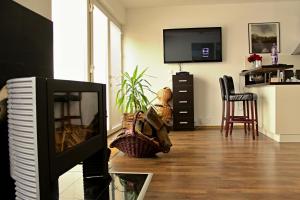 a living room with a television and a table and chairs at Private holiday house Vivendi in Liptovský Mikuláš