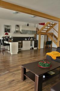 a living room with a couch and a table and a kitchen at Private holiday house Vivendi in Liptovský Mikuláš