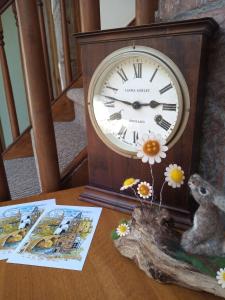 a clock sitting on top of a table at Laurieknowe Coach House in Dumfries
