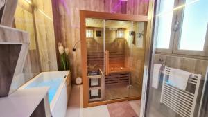 a bathroom with a shower and a tub and a sink at GOLDIE in Zagreb +43 photos