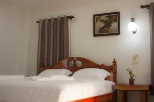 Postel nebo postele na pokoji v ubytování Baan Opun Garden Resort
