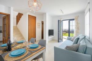 a dining room and living room with a table and chairs at Casa Princesa Gara in Yaiza