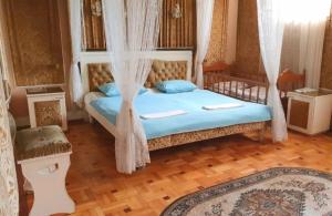 a bedroom with a bed with a canopy at Classic Apartment on Kievyan in Yerevan