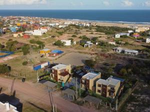 an aerial view of a small town next to the beach at Los Caracoles in Punta Del Diablo