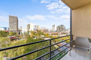 a balcony with a chair and a view of the city at Panorama Place in Reno