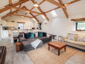 a living room with two couches and a table at Castle Mill in Newport Pembrokeshire