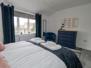 a bedroom with a bed and a blue chair at Middlecroft in York