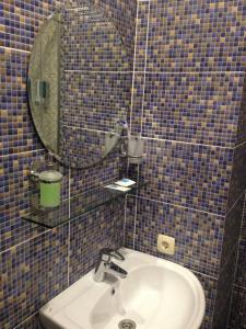 a bathroom with a sink and a mirror at Hotel POSHALE in Bryansk