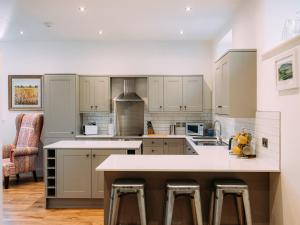 a kitchen with white cabinets and a counter top at The Groomsmen in Clitheroe