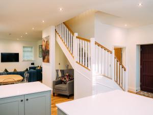 a kitchen and living room with a staircase in a house at The Groomsmen in Clitheroe