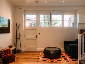 a living room with a couch and a table at The Gardener in Clitheroe