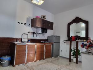 a kitchen with a counter and a refrigerator and a mirror at Spacious 2 BR near mausolée med V, 1min walk tram. in Rabat