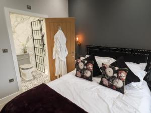 a bedroom with a bed with two pillows on it at Jasmine in Hull