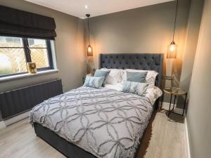 a bedroom with a large bed with pillows at Magnolia in Hull