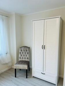 a bedroom with a chair and a closet at LeCiel Maison Lily in Bad Lauterberg