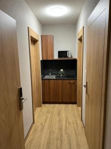 Zimmer mit einem Flur mit einer Tür und einer Mikrowelle in der Unterkunft Apartamenty Polna 60 in Żory
