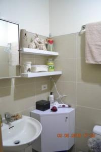 a bathroom with a sink and a mirror at SMDC Wind Loft Bedroom 101 Facing Amenities with WIFI and Parking in Tagaytay