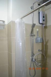 a shower with a shower curtain in a bathroom at SMDC Wind Loft Bedroom 101 Facing Amenities with WIFI and Parking in Tagaytay