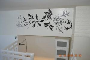 a wall stencil of flowers on a wall at SMDC Wind Loft Bedroom 101 Facing Amenities with WIFI and Parking in Tagaytay