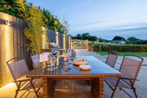 a table and chairs on a patio at Trelights Port Issac in Saint Endellion