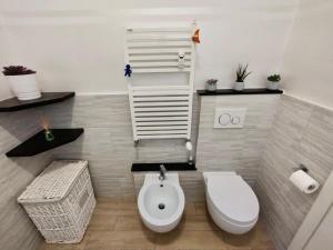 a bathroom with a toilet and a bidet at Elisir Home in Genova