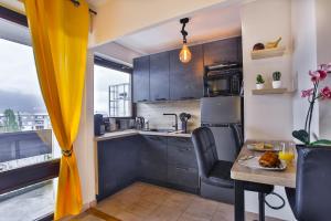 a kitchen with a table and a yellow curtain at Empire New York Signature in Annemasse