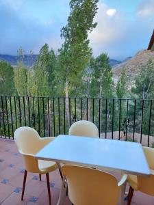 a table and chairs on a balcony with a view at Casa el angel in Castril