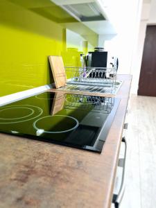a kitchen counter with a dish drying rack on it at Cozy Apartment in Arad