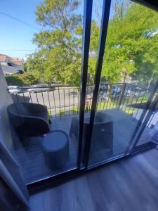 a screened in porch with two chairs and a table at PH playa Grande in Mar del Plata