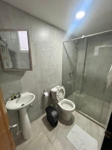 a bathroom with a shower and a toilet and a sink at Hotel Dorado San Luis in San Luis +17 photos