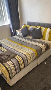 a bed with two pillows on it in a room at Windmill Guest House in Bridlington