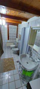 a bathroom with a sink and two toilets at Il Belvedere in Nevegal