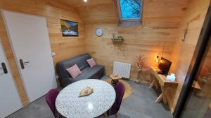 a small living room with a table and a couch at Chalet Sanset in Gèdre