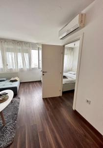 a living room with a bedroom and a bed at Penthouse one bedroom with a view of Zagreb in Zagreb