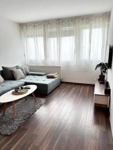 a living room with a couch and a table at Penthouse one bedroom with a view of Zagreb in Zagreb