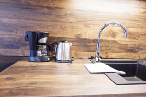 a kitchen counter with a coffeemaker and a coffee maker at Wolfhof_Ritten in Auna di Sopra