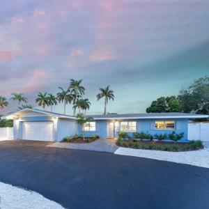 a large house with palm trees in front of it at Paradise By The River-Hottub/Pool-Near Beaches in Bradenton