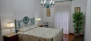 a bedroom with a bed and two lamps and a plant at Elegant Sea View Apartment in Nazaré
