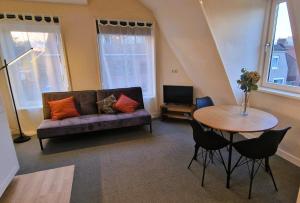 a living room with a couch and a table at Staying-Inn Enschede in Enschede