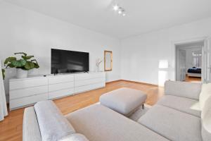 a living room with a couch and a tv at Beautiful 80sqm Appartment in Berlin-Mitte in Berlin