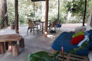 a patio with a bed and a table and chairs at Casa Itza in El Zaino