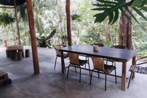 a wooden table and chairs on a patio at Casa Itza in El Zaino