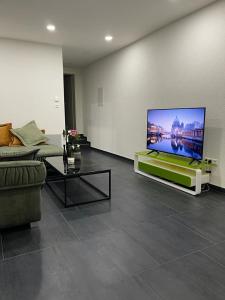 a living room with a large flat screen tv at 2 Zimmer wohnung zur tägliche Miete in Hechingen