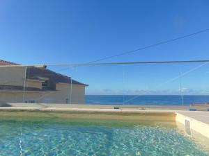uma piscina com vista para o oceano em villa com piscina entre o mar e as montanhas em Paul do Mar