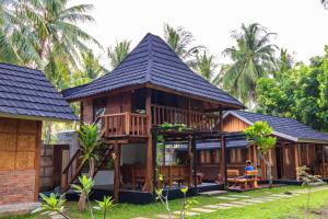 a wooden house with a gambrel roof at Tahlia's Villa in Sorongjukung