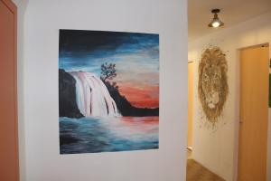 a painting of a waterfall on a wall in a hallway at MMM soirée étape 